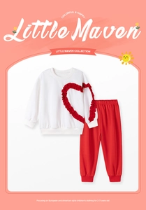 Detail of girls cotton set featuring white sweatshirt with red heart and red joggers