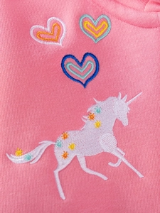 Pink knit girl's sweater with colorful unicorn and heart embroidery for autumn