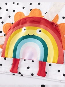 Girl's autumn outfit detail showing 3D rainbow zipper pocket with cute facial features