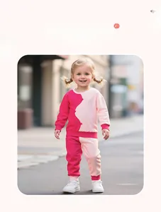 Detail of pink and magenta color-block girls' cotton sweatshirt and pants set in outdoor setting