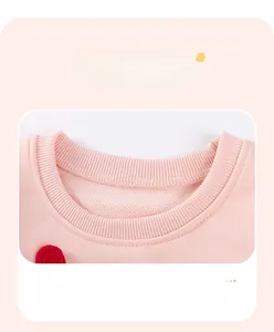 Detail of pink knitted girl outfit showing rib-knit neckline and flatlock seam stitching