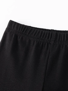 Elastic waist detail of girls black knitted cotton trousers for autumn casual wear
