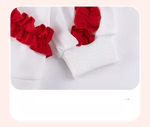 Close-up of white long-sleeved ribbed cuffs featuring vibrant red tiered ruffles for girls