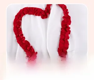 Detailed macro view of white knit fabric with red ruffled lace in a heart shape
