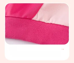 Close-up of pink ribbed knit hem and stitching on a long-sleeved children sweater