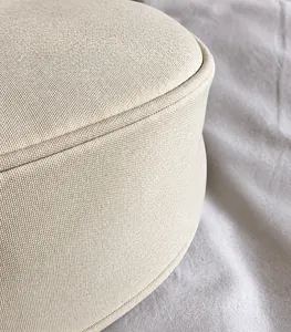 Detail view of beige nylon canvas crossbody bag showing fine fabric texture and neat stitching