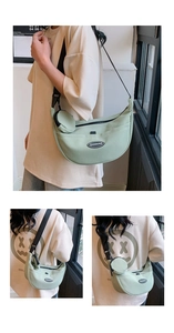 Detail of light green nylon crescent bag with circular pouch and brand logo patch