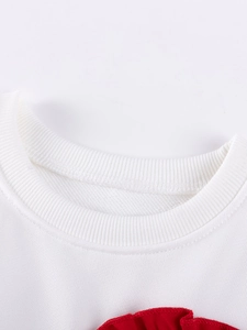 Toddler girl's white cotton sweatshirt featuring a ribbed crewneck and red ruffles