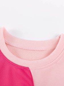 Neckline detail of a two-tone pink crewneck sweatshirt for girls with ribbed stitching