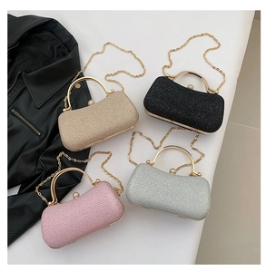 Detail of four shimmer clutch bags with metal ring handles and detachable chain straps