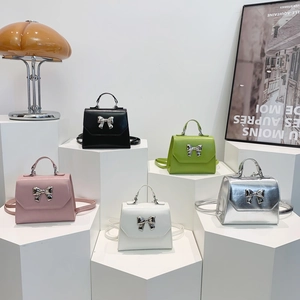 Trendy bow-knot handbag set in five colors featuring crossbody strap and metal hardware