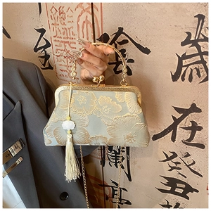 Detailed embroidery on vintage Chinese green silk handbag with gold floral patterns
