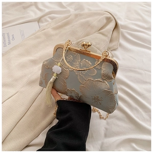Detailed embroidery on vintage qipao bag with metal ring handle and floral tassel