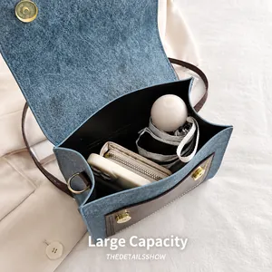 Macro detail showing spacious interior of the blue vintage bag for daily essentials