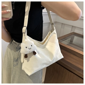 Minimalist white hobo bag detail with adjustable strap and cute cloud plush charm