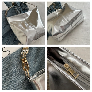 Detail showing silver glossy bucket bag with golden chain straps and zipper closure