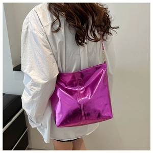 Fuchsia metallic tote bag detail with chain strap and glossy textured finish