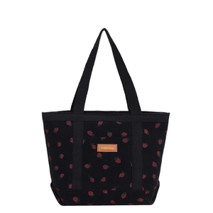 Minimalist black corduroy tote bag with red strawberry print and leather patch detail