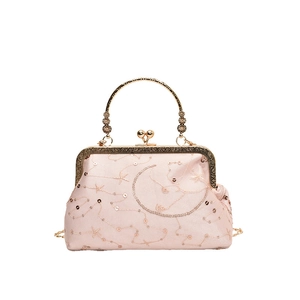 Pink vintage kiss-lock bag with gold celestial embroidery and metallic handle