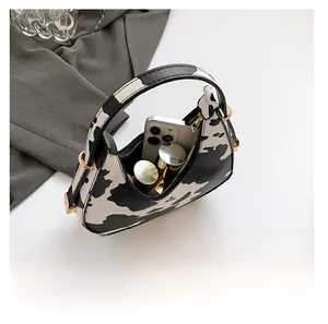 Internal view of zebra print crescent bag showing space for a phone and lipstick