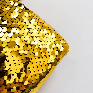 Macro shot of high-quality golden sequins with shimmering fish-scale texture and metallic finish
