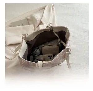 Detail view of large jacquard floral tote bag showing spacious interior and metal chain