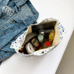 Interior view showing large capacity of the floral tote bag with various daily essentials