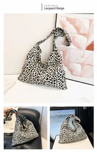 Detail view of large leopard print canvas tote with knotted strap and spacious interior