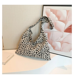 Detail view of the lightweight canvas tote bag featuring a classic leopard print pattern