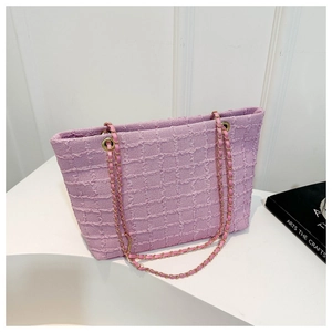 Detail of purple tweed tote bag featuring gold metal chain interwoven with leather straps