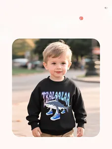 Detail view of a black shark print sweatshirt on a child model in an outdoor park setting