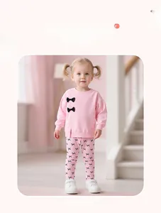 Détail d'ensemble rose fille avec nœuds papillon 3D et motifs imprimés de nœuds