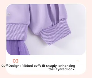 Detail of girl's purple sweatshirt with ribbed cuffs and tiered tulle mesh hemline