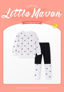 Detail view of cotton long sleeve toddler set with cute black bow pattern for ages 2-7