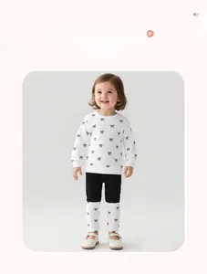 Girls long sleeve sweatshirt and leggings set with black bow patterns and model display