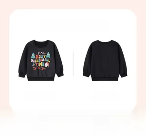 Close-up of black Christmas sweatshirt with colorful festive typography and holiday icons