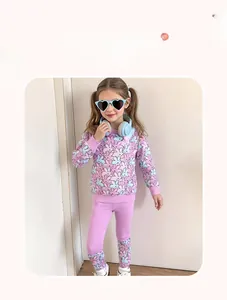 Detail of purple cotton blend girl outfit featuring cute pink and blue rabbit patterns