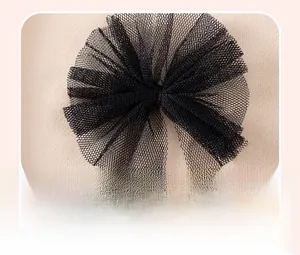 Gros plan sur le nœud en tulle noir 3D sur un vêtement en tricot pour fille couleur abricot