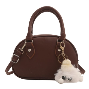 Brown semi-circle bowling handbag with short handles and a cute plush doll pendant