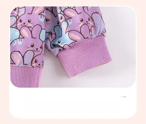 Detail of purple ribbed elastic cuffs and cute cartoon rabbit print on girls' autumn top