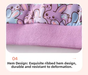 Detail view of purple sweatshirt ribbed hem featuring cute cartoon bunny prints