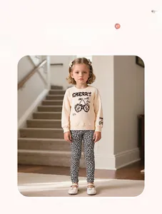 Detail of girls' cream sweatshirt with leopard cherry print and matching leggings
