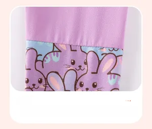 Detailed view of knitted purple cuffs with cute cartoon rabbit print patchwork fabric