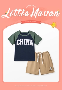 Detail of navy boy's t-shirt with CHINA print and khaki shorts featuring dog graphics