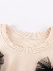 Haut mignon à manches longues beige pour petite fille avec nœuds en tulle noir