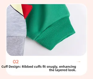 Detail of green ribbed cuffs and dinosaur jagged trim on boys' cotton fleece sweatshirt