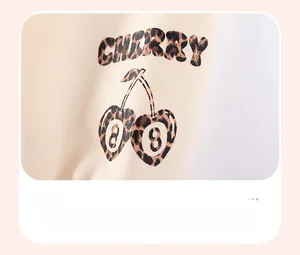 Detail of cherry heat transfer print and leopard pattern on girls' knit sweatshirt cuff