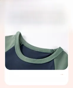 Detail of the navy blue and green ribbed crew neck on a cotton toddler t-shirt