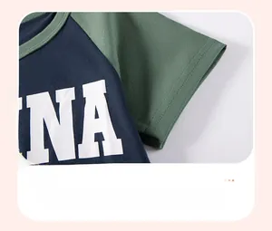 Detail shot of navy and dark green raglan sleeves with smooth stitching and soft knit fabric