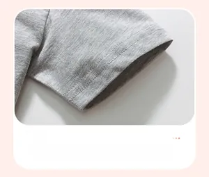 Dettaglio dell'orlo della manica della t-shirt grigia da bambino con doppia cucitura rifinita